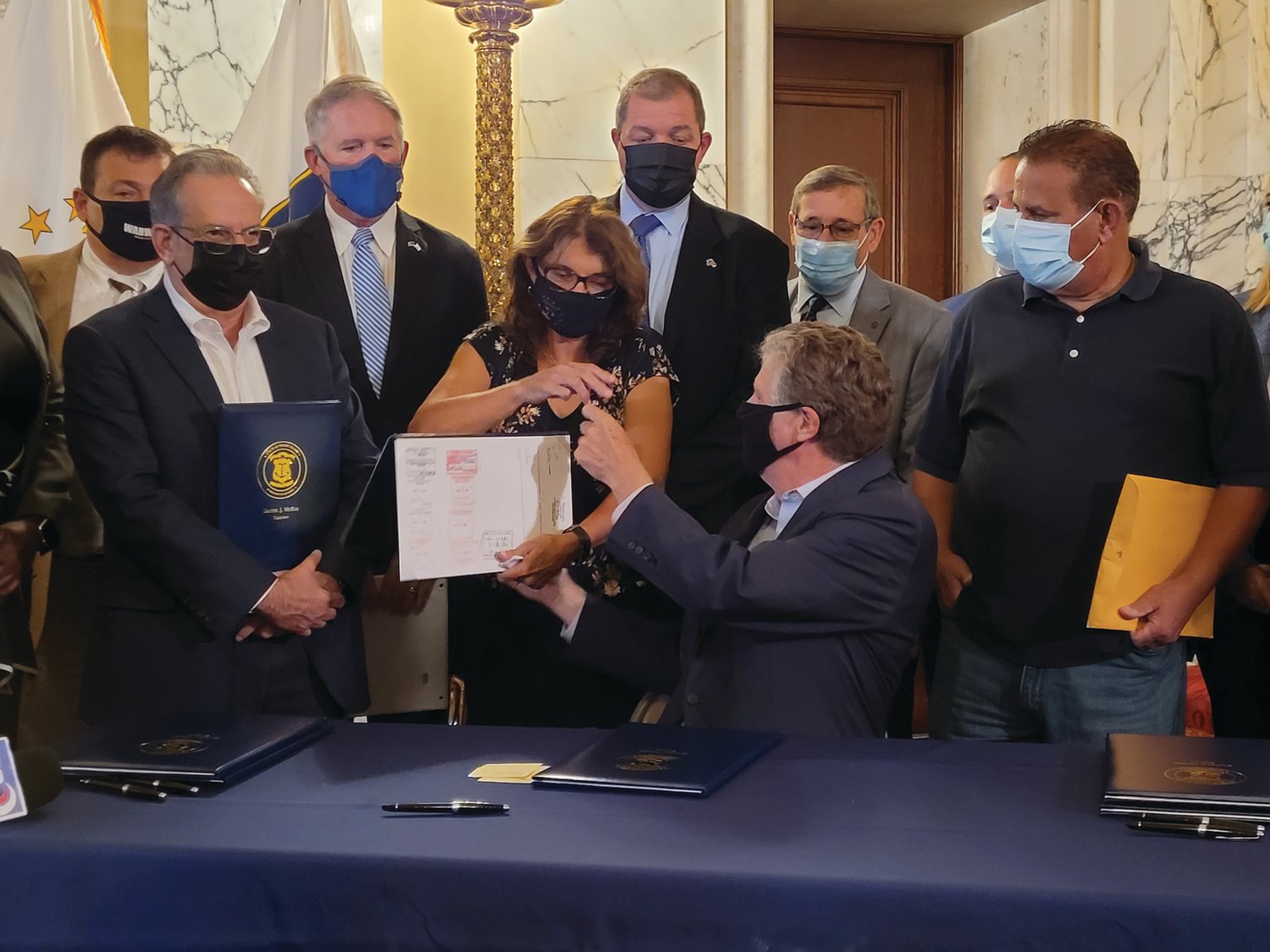 ‘RYAN’S LAW’: Rhode Island Gov. Dan McKee handed the pen he used to sign the legislation that may ultimately be known as “Ryan’s Law” to co-sponsor state Rep. Deborah Fellela, who then gave the pen to Cranston resident and Johnston native Lou Massemini, who’s son’s death helped inspire the bill.